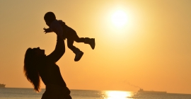 Mother holding child in air